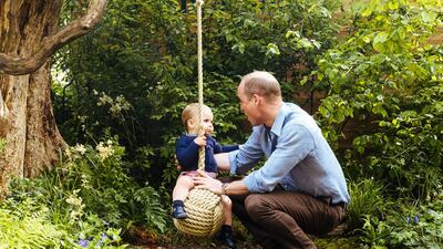 Prince William with Prince Louis on the swing. Matt Porteous / Kensington Palace via Getty Images