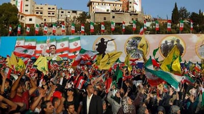 Hizbollah supporters wave Hizbollah, Iranian and Lebanese flags during a rally for the Iranian President Mahmoud Ahmadinejad's visit to Bint Jbeil in southern Lebanon on Thursday.