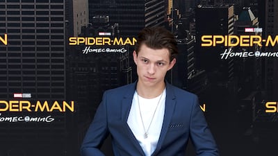 Tom Holland, in jeans, a white T-shirt and navy blazer, attends a 'Spider-Man: Homecoming' photocall in Madrid on June 14, 2017. Getty Images