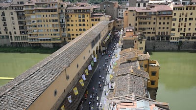 Cyclists cross Ponte Vecchio in Florence before the start of Stage 1 of the Tour de France. EPA