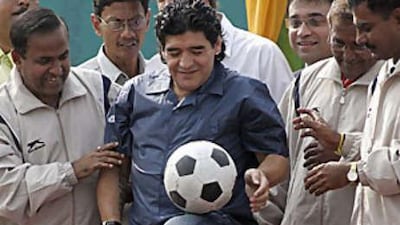 Diego Maradona, centre, shows his skills during a stone-laying ceremony for the Indian Football School in Calcutta.