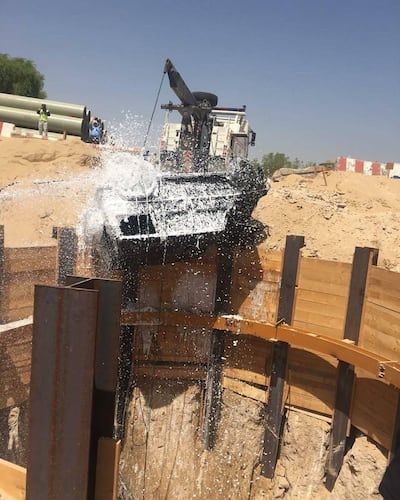 The car is recovered from the hole, in Al Khawaneej, Dubai. Courtesy Dubai Civil Defence