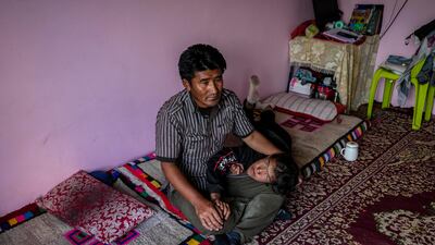 Mr Dorjey and Jigmet in their home.