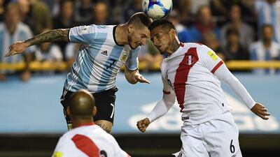 Argentina's Dario Benedetto and Peru's Miguel Trauco (R) vie for the ball during their 2018 World Cup football qualifier match in Buenos Aires on October 5, 2017. / AFP PHOTO / EITAN ABRAMOVICH