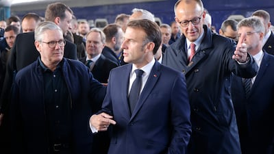 Mr Macron, centre, Mr Starmer, left, and Mr Merz. EPA