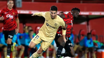 Barcelona forward Ferran Torres vies for the ball with Mallorca midfielder Iddrisu Baba. AFP