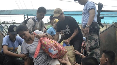 Residents living near the slopes of Mount Mayon volcano are evacuated to public schools by police in anticipation of the powerful typhoon Haiyan that threatened Albay province and several provinces in central Philippines. Nelson Salting / AP Photo