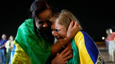Supporters of Brazil's former president Jair Bolsonaro attend a vigil near his home in Brasilia, where he is under house arrest. AP
