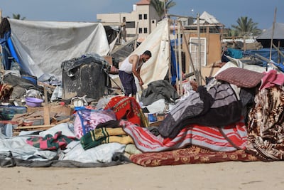 Palestinians salvage items from the site of Israeli bombardment at the al-Mawasi camp. AFP