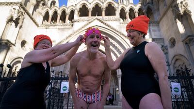 Swimmers from Hampstead Ponds outside the Royal Courts of Justice, London, on Wednesday, as they await the result of a judicial review over whether the charges for bathing at the ponds in Hampstead Heath, London, unlawfully discriminate against disabled people. PA
