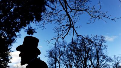 Portraying US President Abraham Lincoln, Tom Scott talks to visitors during a commemoration of the 150th Anniversary of the Gettysburg Address at the Soldiers' National Cemetery at Gettysburg National Military Park, Gettysburg, Pennsylvania. Patrick Smith/Getty Images/AFP