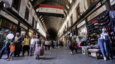 Syrians walk through Damascus' al-Hamidiyah souk on the second day of the Muslim month of Ramadan. Louai Beshara / AFP