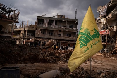A Hezbollah flag in front of buildings destroyed by an air strike in Nabi Chit, Lebanon. Getty Images