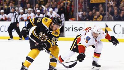 Jyrki Jokipakka, right, of the Calgary Flames defends Brad Marchand of the Boston Bruins during the third period at TD Garden on March 1, 2016 in Boston, Massachusetts. The Bruins defeat the Flames 2-1. Maddie Meyer/Getty Images