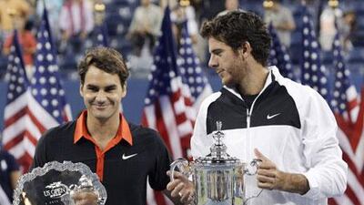 Juan Martin del Potro (right) holds the champions trophy after his shock defeat of Roger Federer in the men's singles final.