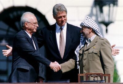 Yasser Arafat, right, shakes hands with Yitzhak Rabin in Bill Clinton's presence after signing their peace accord in Washington. Reuters