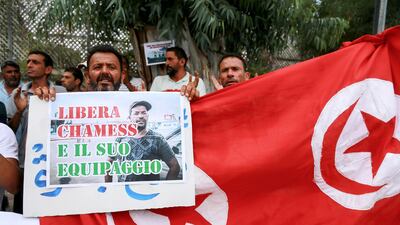 A protester outside the Italian embassy in Tunis calls for the release of a fisherman arrested by Italian authorities for rescuing migrants in international waters and taking them to Italy. AFP