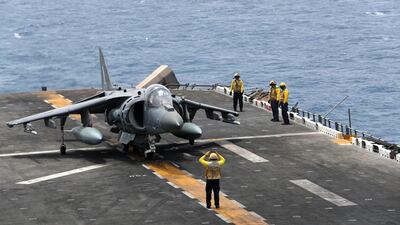 A US Navy officer directs the AV-8B Harrier aircraft.