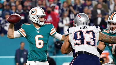 Miami Dolphins quarterback Jay Cutler, left, throws a pass as New England Patriots defensive end Lawrence Guy applies pressure during the first half at Hard Rock Stadium. Steve Mitchell / USA Today