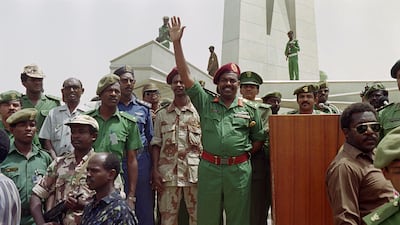 Picture taken on July 11, 1989 at Khartoum showing Sudanese military and political leader Omar al-Bashir waving his supporters during a rally. (Photo by Mike NELSON / AFP)