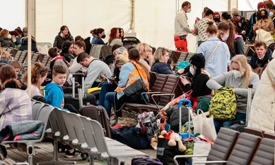 Refugees from Ukraine wait at a disused Berlin airport after arriving in Germany. Getty