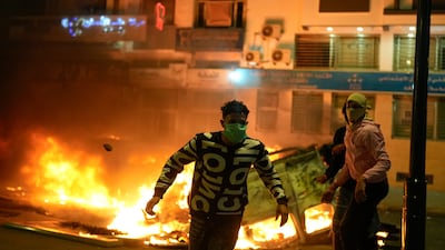 Police vehicles are set on fire as youth-led protests calling for healthcare and education reforms turn violent, in Sale, Morocco. AP