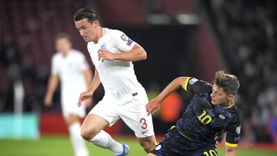 Ben Chilwell of England is tackled by Florent Muslija of Kosovo.