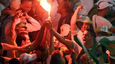 Algeria fans light a flare after Islam Slimani's goal against Russia on Thursday at the 2014 World Cup. Michael Sohn / AP