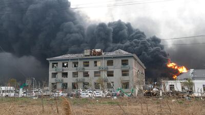 Smoke billows from fire behind a damaged building following the explosion at the pesticide plant owned by Tianjiayi Chemical. Reuters