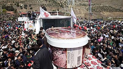 A two metres in diameter and 1.60 metres in height pot filled with five tons of chocolate ice cream north of Tehran/.