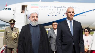 Swiss president Alain Berset, right, welcomes Iranian president Hassan Rouhani, left, during his visit to Switzerland at the Zurich airport. Peter Klaunzer / EPA