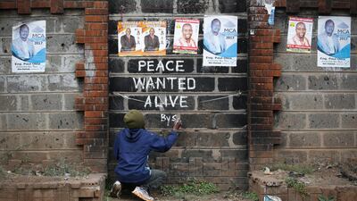 Street artist Solomon Muyundo, also known as Solo7, paints a message of peace on the wall in Kibera slum, one of the opposition leader Raila Odinga's strongholds in the capital Nairobi. DAI KUROKAWA / EPA