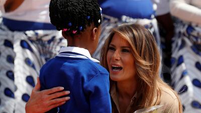 Melania Trump greets a girl giving her flowers at the airport in Lilongwe, Malawi. Carlo Allegri / Reuters