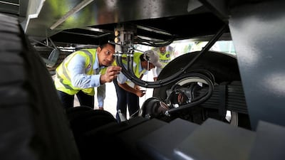 Inspectors from the Department of Transport and Traffic police department staff inspecting a truck near Park Rotana hotel in Abu Dhabi. Ravindranath K / The National