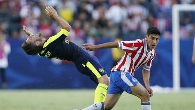 Arsenal’s Mathieu Debuchy, left, reacts after fighting for the ball with CD Guadalajara’s Alejandro Zendejas, right, during the second half of a friendly match in Carson, California, Sunday, July 31, 2016. Danny Moloshok / AP Photo