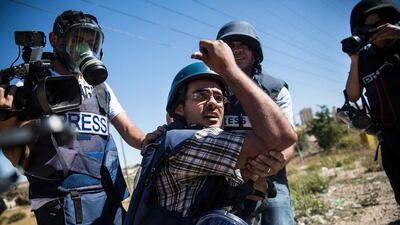 The media plays a role in how Americans view events and people in Gaza. Andrew Burton/Getty Images)