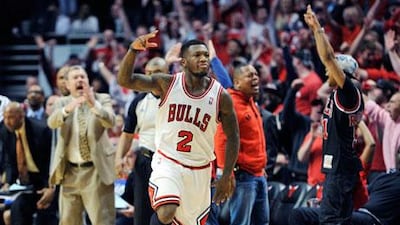 Chicago Bulls' Nate Robinson celebrates a basket against the Brooklyn Nets. Jim Prisching / AP Photo