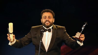 Egyptian director Ahmed Fawzy Salah receives an award for his film 'Poisonous Roses' during the closing ceremony of the 40th edition of the Cairo International Film Festival at the Opera House. Photo / Reuters