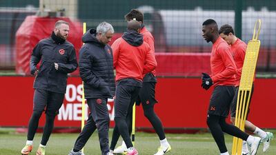 Manchester United's Wayne Rooney, left, and manager Jose Mourinho with teammates during training. Ed Sykes / Reuters