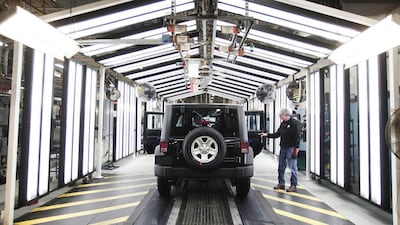 A 2014 Jeep Wrangler undergoes quality inspection during assembly. Bill Pugliano / Getty Images / AFP