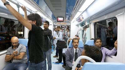 People travelling on the Dubai Metro. Pawan Singh / The National