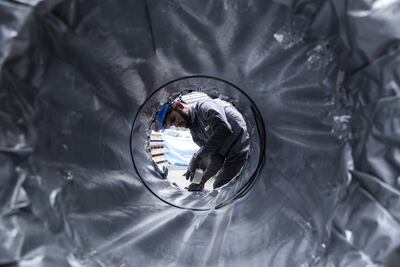 An employee uses tape to seal a packaged coil of rolled steel at the Jindal Stainless Ltd. factory in Hisar, Haryana, India, on Wednesday, May 16, 2018. Photographer: Udit Kulshrestha/Bloomberg