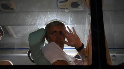 Manchester United manager Jose Mourinho waves to fans from the team bus after a training session on Sunday. Greg Baker / AFP / July 24, 2016