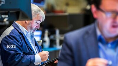 Traders work on the floor of the New York Stock Exchange. Oil prices edged higher on Wednesday after plummeting overnight on demand concerns. AP