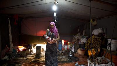 Wazeera Elaiwi, 29, holds her son Mohammed, 2 months old.