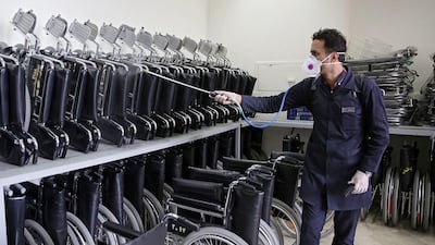 Wheelchairs are sprayed with disinfectant at Imam Reza's holy shrine. West Asia News Agency via Reuters