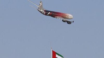 An Etihad Airways Airbus A340 flies over the control tower at Yas Marina Circuit, in Abu Dhabi. Ali Haider / EPA