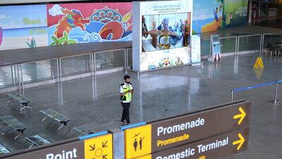 An officer stands at Ngurah Rai International Airport as Indonesia's resort island of Bali reopens for international flights following border closures brought about by the coronavirus disease (COVID-19) pandemic in Badung, Bali, Indonesia October 14, 2021, in this photo taken by Antara Foto/Fikri Yusuf/via REUTERS. ATTENTION EDITORS - THIS IMAGE WAS PROVIDED BY THIRD PARTY. MANDATORY CREDIT. INDONESIA OUT.
