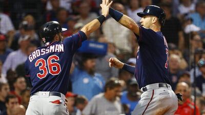 Joe Mauer, right, high fives Robbie Grossman of the Minnesota Twins after scorig in the fourth inning of a game against the Boston Red Sox at Fenway Park on June 29, 2017 in Boston, Massachusetts. Adam Glanzman / Getty Images