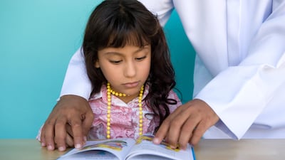 Children interact with their parents more when reading from a traditional story book, study finds. Getty Images